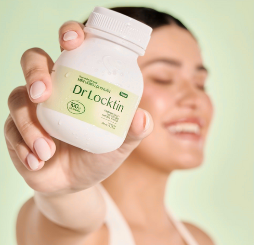 Woman wearing straw hat with sunlight creating dappled shadows on face